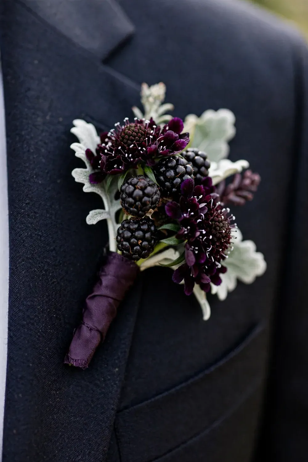 Blackberry boutonniere on groom's lapel