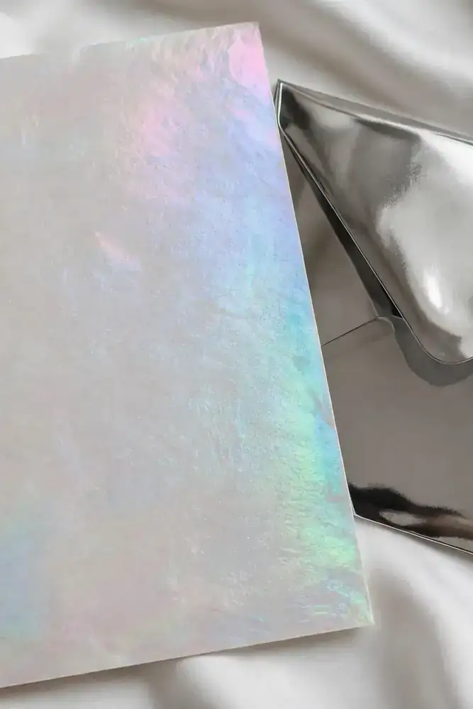Iridescent opalite wedding invitation with chrome envelope on silk