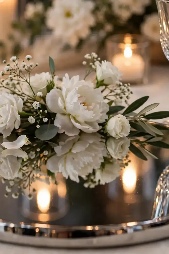 Mirrored chrome charger plate reflecting candlelight at wedding table