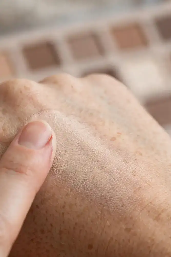 Fingertip blending eyeshadow primer swatch on back of hand