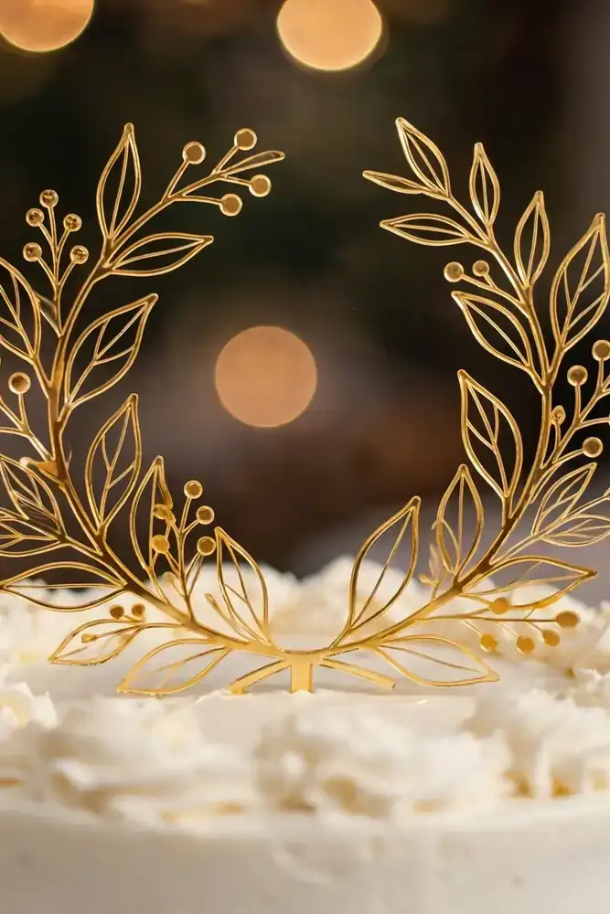 Gold cake topper on a white wedding cake