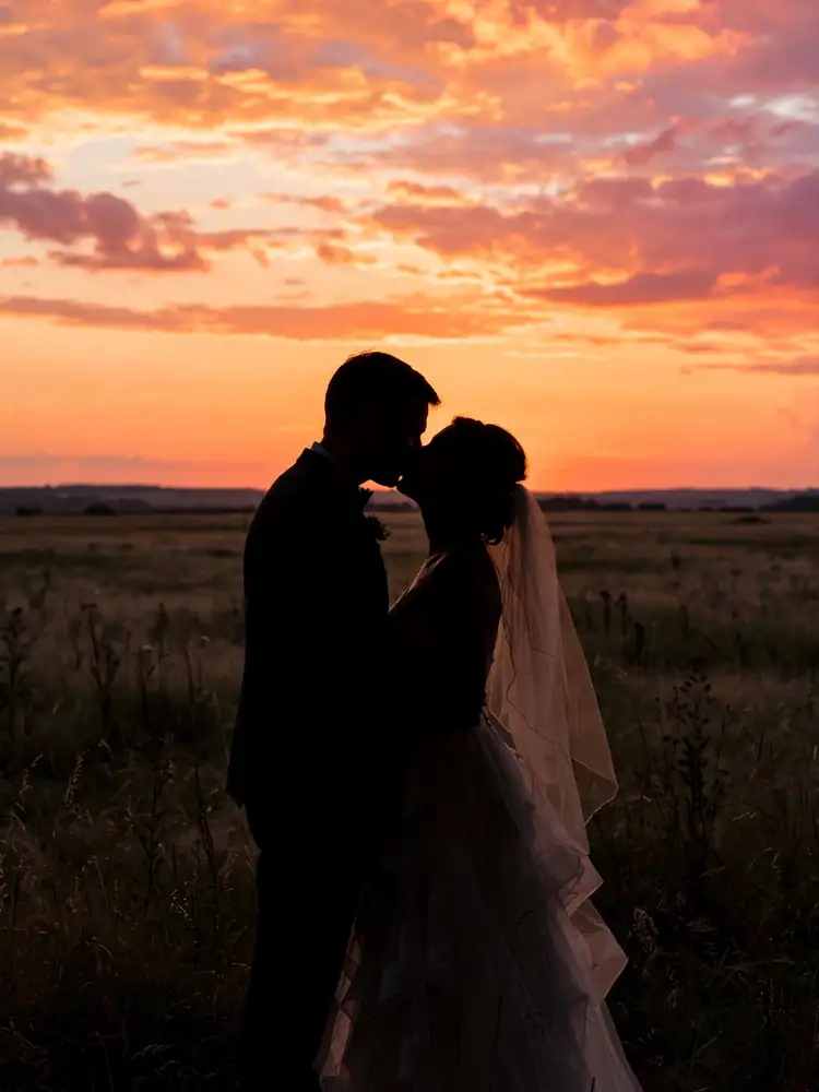 Silhouette kiss wedding pose at sunset