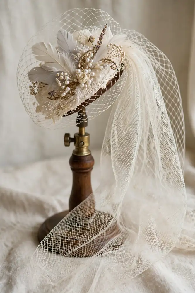 Birdcage bridal veil of ivory netting on a vintage fascinator stand